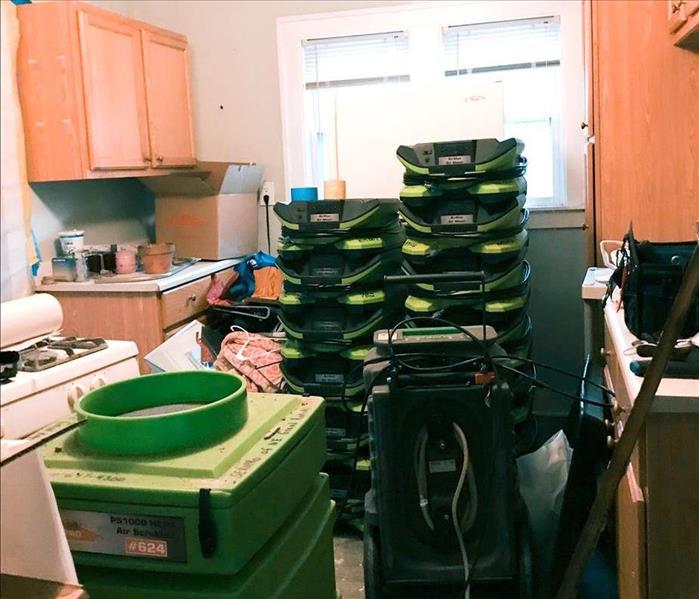 Air movers stacked in customer kitchen