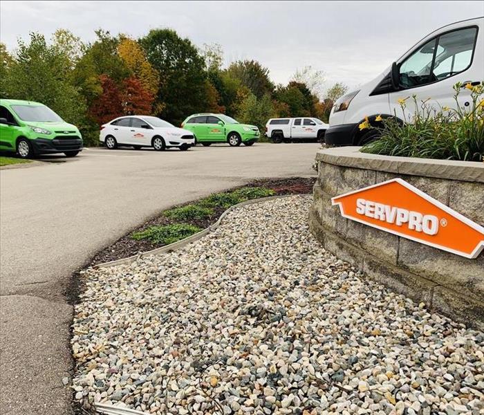 SERVPRO sign with vehicles in parking lot