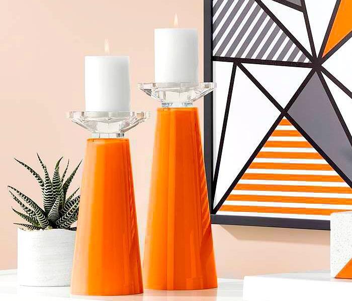 White candles on thick, orange candle sticks. 